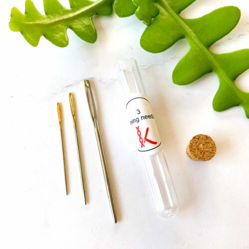 3 darning needles in storage tube